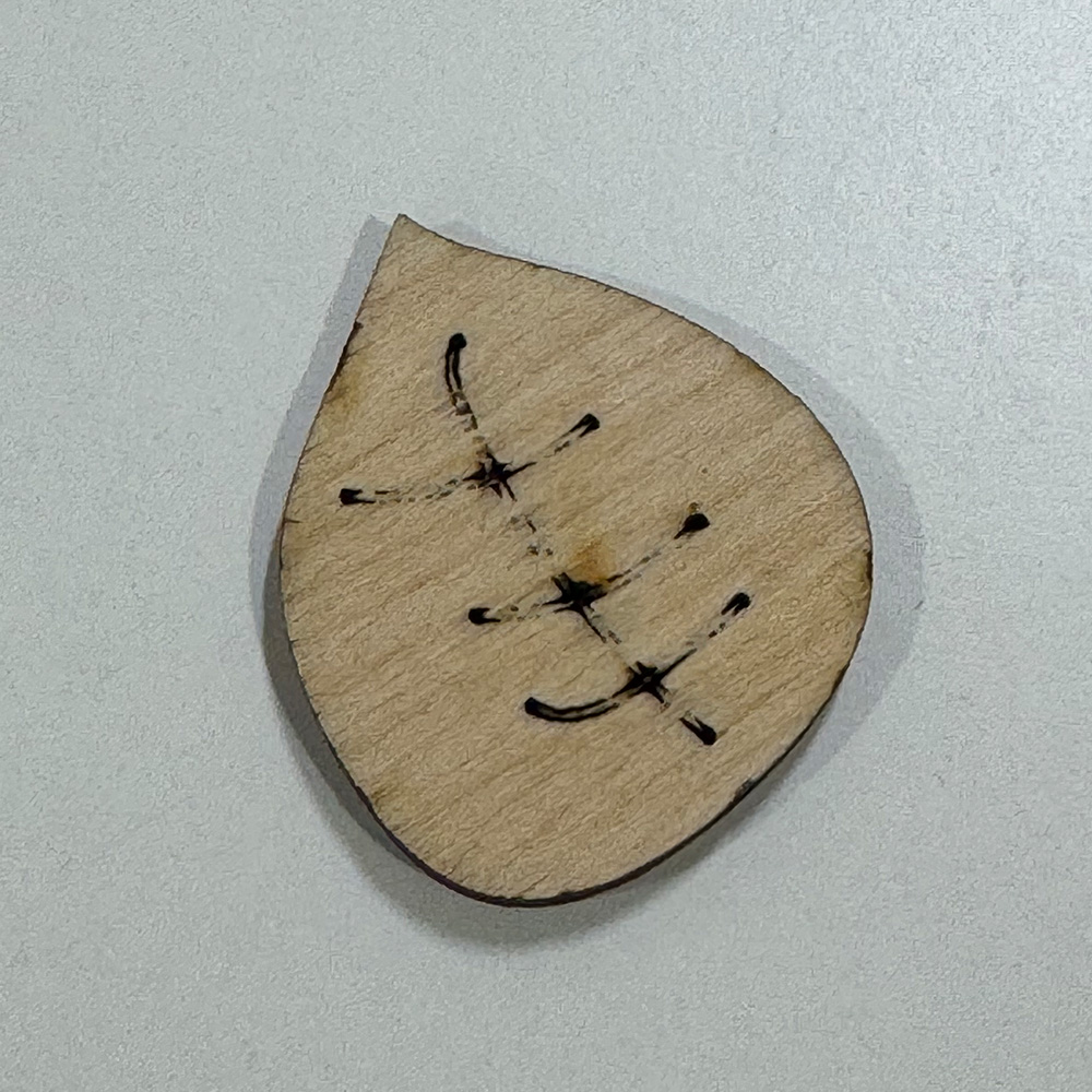 This is the back of one of my laser cut leaves. Due to the significant usage of the laser the smoke produced can block the sensor thus ocassionally not completely cutting through the wood.